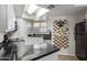 Bright kitchen with black countertops, white cabinets, and a skylight providing natural light at 2228 N 52Nd St # 140, Phoenix, AZ 85008