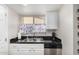 Kitchen features stainless steel appliances, double sink, and window with patterned curtain at 2228 N 52Nd St # 140, Phoenix, AZ 85008