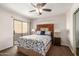 Bedroom with ceiling fan, sliding glass door to patio, and decorative headboard at 2228 N 52Nd St # 140, Phoenix, AZ 85008