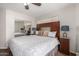 Relaxing bedroom featuring a decorative headboard, ceiling fan, and mirrored closet doors at 2228 N 52Nd St # 140, Phoenix, AZ 85008