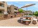 Outdoor dining area with built-in grills and seating near the pool at 2228 N 52Nd St # 140, Phoenix, AZ 85008
