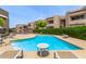 Inviting community pool with comfortable lounge chairs, surrounded by attractive landscaping and multi-story residential buildings at 2228 N 52Nd St # 140, Phoenix, AZ 85008