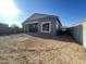 Unfinished backyard featuring a covered patio and block wall fence, perfect for creating your dream outdoor space at 22669 E Saddle Way, Queen Creek, AZ 85142