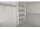 Walk-in closet has built-in shelving, maximizing space for clothing and accessory organization at 22669 E Saddle Way, Queen Creek, AZ 85142
