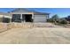 Picture of a single Gathering home still under construction with a two car garage and desert landscaping at 22669 E Saddle Way, Queen Creek, AZ 85142