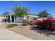 Beautiful single Gathering home with a two-car garage and desert landscaping with mature trees and bougainvillea bushes at 22669 E Saddle Way, Queen Creek, AZ 85142