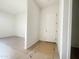 Clean entryway of home with wood look tile and white trim at 22669 E Saddle Way, Queen Creek, AZ 85142