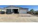 New construction exterior elevation with covered entry, brick-paved driveway, and attached two-car garage at 22669 E Saddle Way, Queen Creek, AZ 85142