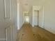 Bright hallway with wood-look tile flooring and white walls; a closet is visible on the right at 22669 E Saddle Way, Queen Creek, AZ 85142