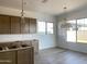 New kitchen boasts modern cabinets, fixtures and adjacent dining area flooded with natural light at 22669 E Saddle Way, Queen Creek, AZ 85142