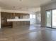 Open-concept layout with gourmet kitchen leading into a bright living area, great for entertaining at 22669 E Saddle Way, Queen Creek, AZ 85142