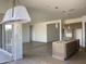 Spacious open-concept kitchen with center island and pendant lighting, transitional to living spaces at 22669 E Saddle Way, Queen Creek, AZ 85142