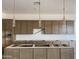 Modern kitchen featuring brown cabinets and recessed lighting throughout at 22669 E Saddle Way, Queen Creek, AZ 85142