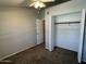 Bedroom with closet, neutral walls, carpet, and ceiling fan at 2301 E University Dr # 269, Mesa, AZ 85213