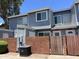 Two-story gray townhome with a brick privacy wall and well-maintained landscaping at 2301 E University Dr # 269, Mesa, AZ 85213