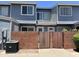 Exterior view of townhomes with brick wall, wooden fence, and air conditioning unit at 2301 E University Dr # 269, Mesa, AZ 85213