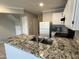 Updated kitchen with granite countertops and views of stainless steel appliances and adjacent closet at 2301 E University Dr # 269, Mesa, AZ 85213