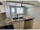 Granite countertops in an updated kitchen with a view of the sliding glass door at 2301 E University Dr # 269, Mesa, AZ 85213