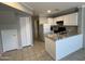Modern kitchen with granite countertops, white cabinets, and updated appliances at 2301 E University Dr # 269, Mesa, AZ 85213