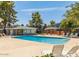 Community pool with lounge chairs around the perimeter, along with a gazebo, trees, and a brick pool house at 2301 E University Dr # 269, Mesa, AZ 85213