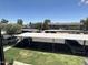 View of covered parking and landscaping from a window with white blinds at 2301 E University Dr # 269, Mesa, AZ 85213