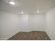 Finished basement with stylish wood-look floors and white walls is ready for your imagination at 2430 W Papago St, Phoenix, AZ 85009