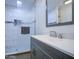 Bathroom features a gray vanity, white countertop, and a glass-enclosed shower at 2430 W Papago St, Phoenix, AZ 85009