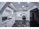 Modern kitchen with white cabinets, stainless steel appliances, and stylish tile flooring at 2430 W Papago St, Phoenix, AZ 85009