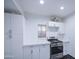 Bright kitchen featuring white cabinetry, stainless steel oven range and black and white tile floor at 2430 W Papago St, Phoenix, AZ 85009