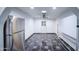 Bright room featuring tile floor, whiteboard, stainless steel refrigerator and ceiling fan at 2430 W Papago St, Phoenix, AZ 85009