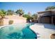 Backyard features a pool with a rock waterfall and ample space for entertaining at 2533 N 114Th Ave, Avondale, AZ 85392