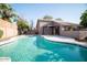 This inviting backyard features a sparkling pool, lush landscaping, and room for relaxation at 2533 N 114Th Ave, Avondale, AZ 85392