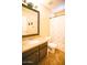 Bathroom showcasing a granite countertop vanity, toilet, and shower with decorative elephants on the curtain at 2533 N 114Th Ave, Avondale, AZ 85392