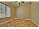 Neutral bedroom featuring tile floor, bright window and base trim at 2533 N 114Th Ave, Avondale, AZ 85392
