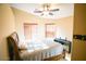 Well-lit bedroom with a ceiling fan, two windows, and a piano on the right at 2533 N 114Th Ave, Avondale, AZ 85392