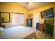 Vaulted ceiling bedroom with a large window, TV, desk, and comfortable bed at 2533 N 114Th Ave, Avondale, AZ 85392