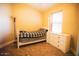 Comfortable bedroom with a four-poster bed, plaid bedding, and a dresser at 2533 N 114Th Ave, Avondale, AZ 85392