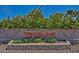 Exterior stone sign for Crystal Ridge Terraces surrounded by plants and flowers at 2533 N 114Th Ave, Avondale, AZ 85392