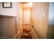Hallway showcasing neutral walls, tiled flooring, and access to various rooms at 2533 N 114Th Ave, Avondale, AZ 85392
