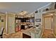 Open kitchen with stainless steel appliances, dark wood cabinets, granite countertop, tile floor and breakfast bar at 2533 N 114Th Ave, Avondale, AZ 85392
