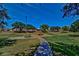 Community playground surrounded by large trees and walkway at 2533 N 114Th Ave, Avondale, AZ 85392