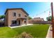 A spacious backyard offers a pristine artificial lawn, rear patio, and ambient string lights at 2918 E Silverbell Rd, San Tan Valley, AZ 85143