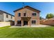 The expansive artificial lawn stretches to the home, featuring a covered patio and ambient lighting at 2918 E Silverbell Rd, San Tan Valley, AZ 85143