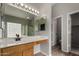 Bathroom featuring double mirrors and a vanity, with an adjacent glass shower enclosure at 2918 E Silverbell Rd, San Tan Valley, AZ 85143