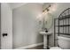 Elegant half-bathroom with modern sink and light fixtures, complemented by wood-look flooring at 2918 E Silverbell Rd, San Tan Valley, AZ 85143