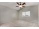 Bright bedroom with neutral carpet, ceiling fan, and window letting in natural light at 2918 E Silverbell Rd, San Tan Valley, AZ 85143