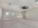 This bonus room has neutral paint, ceiling fan and carpet at 2918 E Silverbell Rd, San Tan Valley, AZ 85143