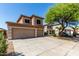 Inviting two-story home with a spacious three-car garage, long driveway, and mature landscaping at 2918 E Silverbell Rd, San Tan Valley, AZ 85143
