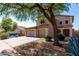 Charming two-story home with a spacious driveway, three-car garage, and mature tree at 2918 E Silverbell Rd, San Tan Valley, AZ 85143