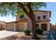 Charming two-story home with a spacious driveway, three-car garage, and mature trees at 2918 E Silverbell Rd, San Tan Valley, AZ 85143